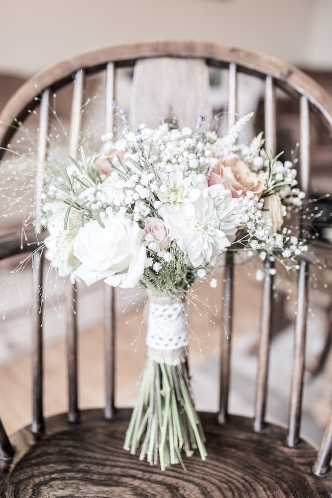 A bundle of flowers on a chair.